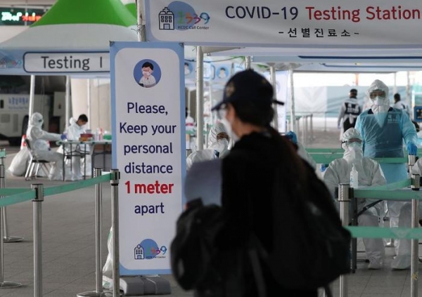 인천공항에 설치된 개방형 선별진료소에서 한 입국자가 검체 채취를 받고 있다.(사진=국민소통실)
